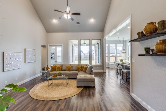 living room with dark wood-type flooring, high vaulted ceiling, and ceiling fan