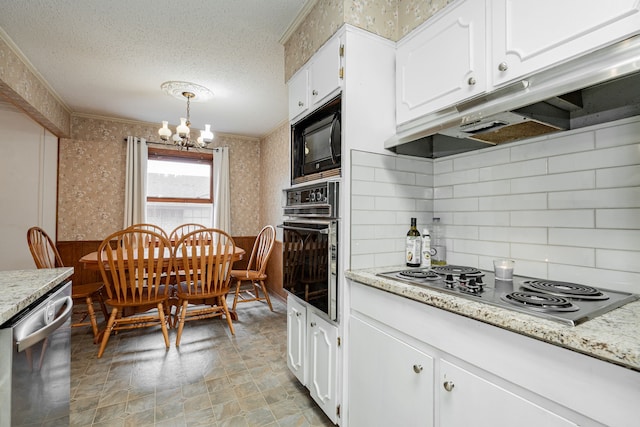 kitchen with white cabinetry, hanging light fixtures, a textured ceiling, a notable chandelier, and black appliances