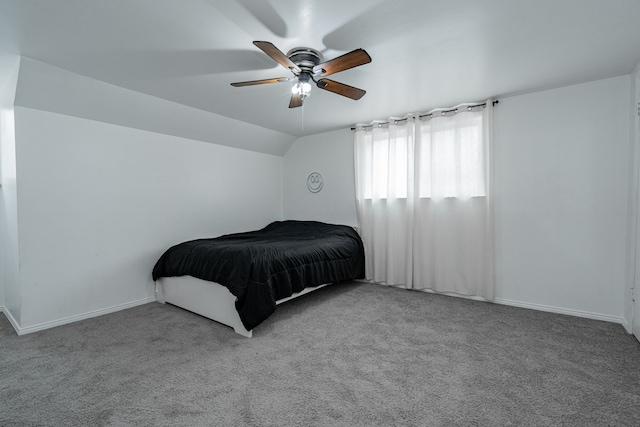 bedroom featuring vaulted ceiling, light colored carpet, and ceiling fan