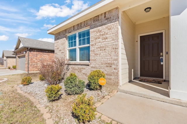 view of exterior entry with a garage