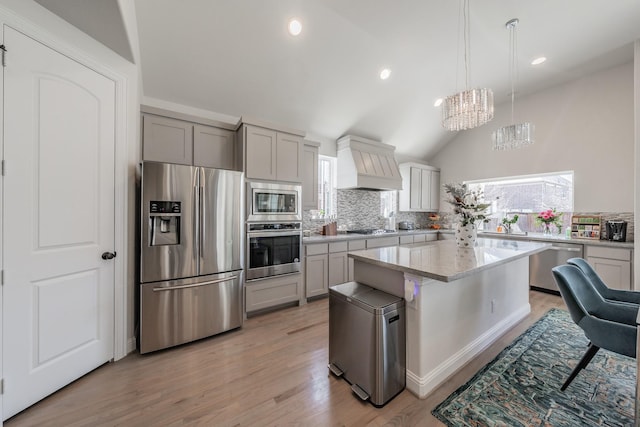 kitchen with premium range hood, a kitchen island, pendant lighting, decorative backsplash, and stainless steel appliances