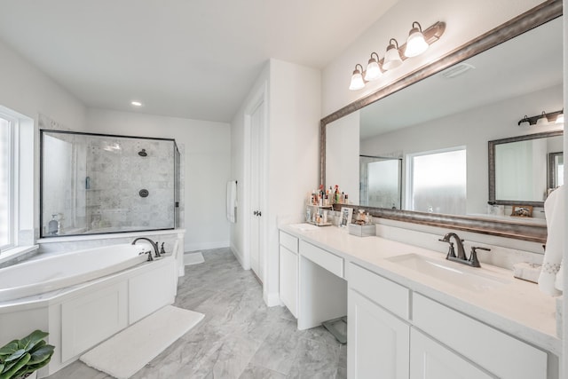 bathroom with vanity and shower with separate bathtub