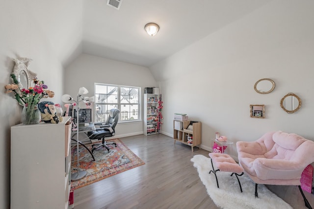 home office with wood-type flooring and vaulted ceiling