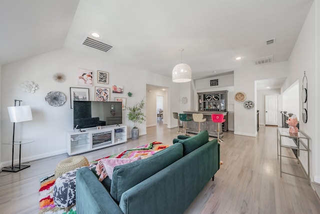 living room with lofted ceiling and light hardwood / wood-style flooring