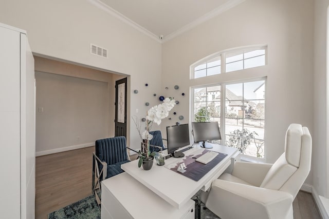 home office featuring a high ceiling, crown molding, and dark hardwood / wood-style floors