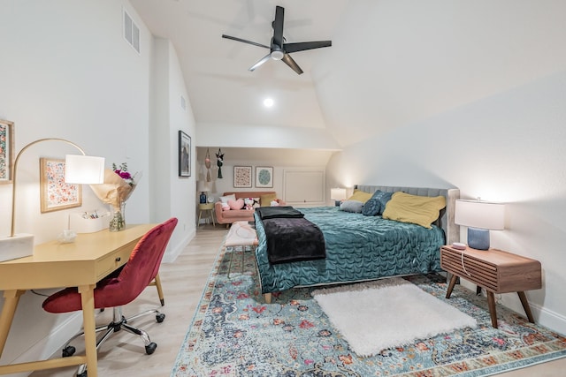 bedroom with ceiling fan, lofted ceiling, and light hardwood / wood-style flooring