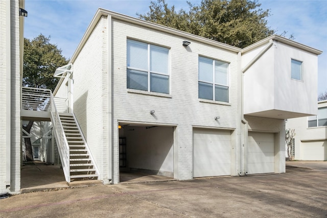 rear view of property with a garage