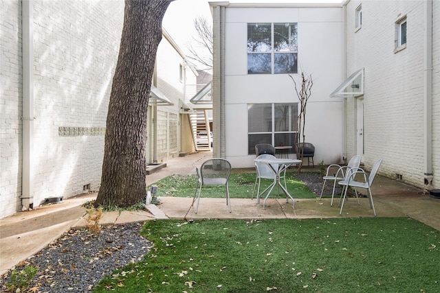 rear view of house with a patio area and a lawn