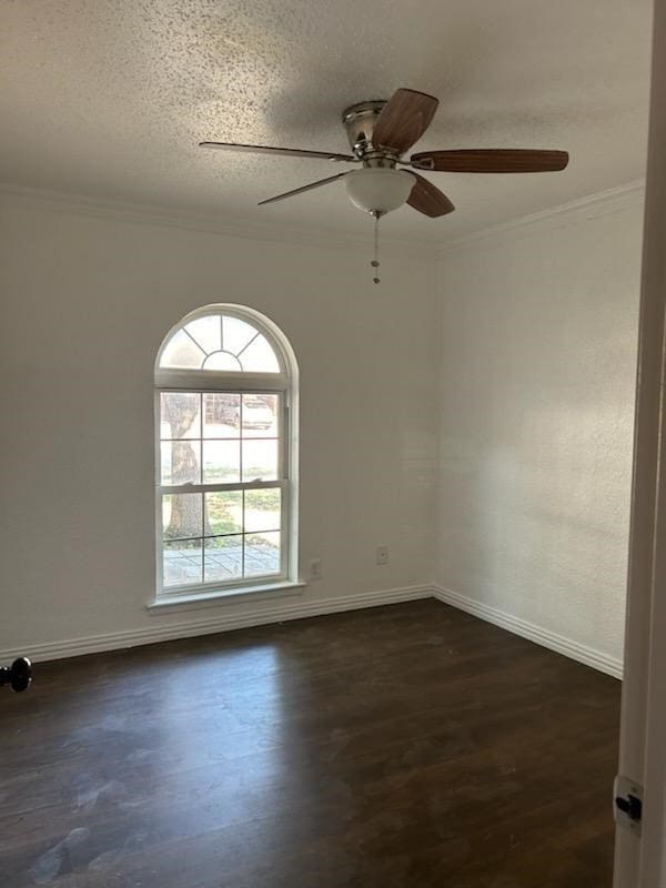 spare room with ornamental molding, dark hardwood / wood-style floors, ceiling fan, and a textured ceiling