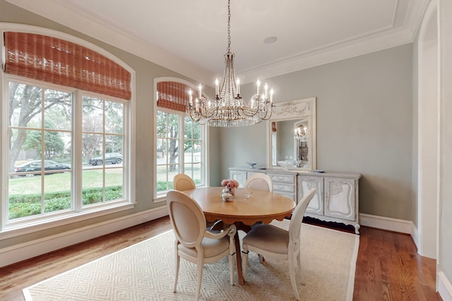 dining room featuring hardwood / wood-style flooring and ornamental molding