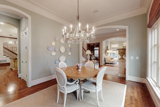 dining space featuring crown molding and wood-type flooring