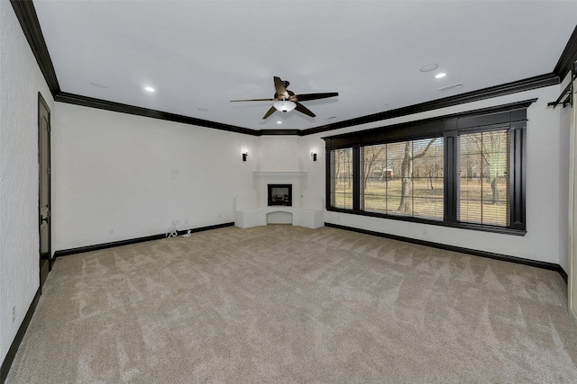 unfurnished living room featuring crown molding, light carpet, and ceiling fan