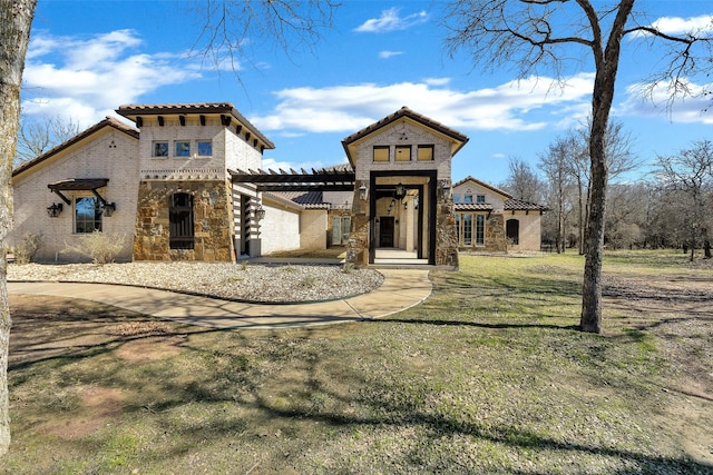 mediterranean / spanish-style home featuring a front yard