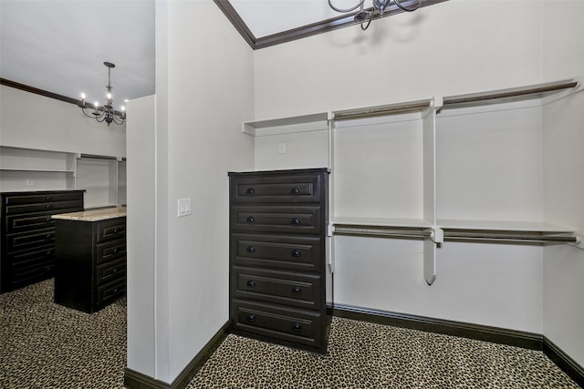 walk in closet with an inviting chandelier and dark carpet