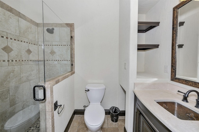 bathroom with an enclosed shower, vanity, and toilet