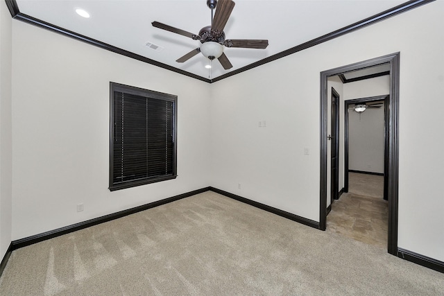 carpeted spare room featuring ornamental molding and ceiling fan