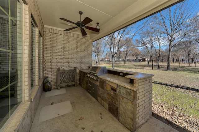 view of patio / terrace featuring exterior kitchen, ceiling fan, and grilling area