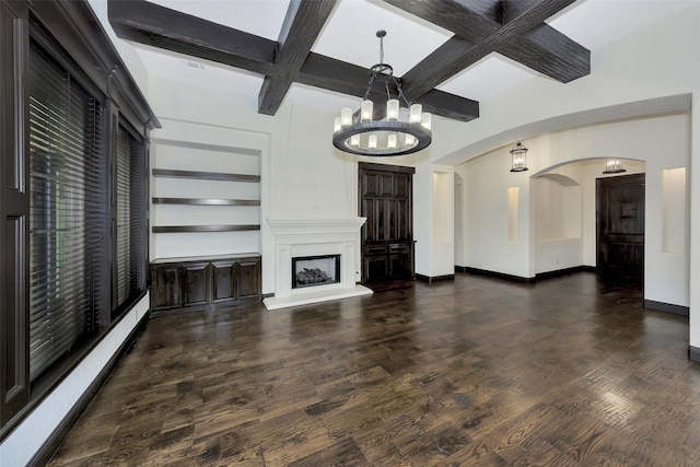 unfurnished living room with coffered ceiling, an inviting chandelier, dark hardwood / wood-style floors, beam ceiling, and a baseboard heating unit