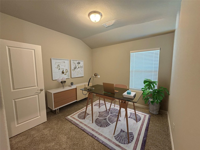 office space featuring vaulted ceiling, carpet floors, and a textured ceiling