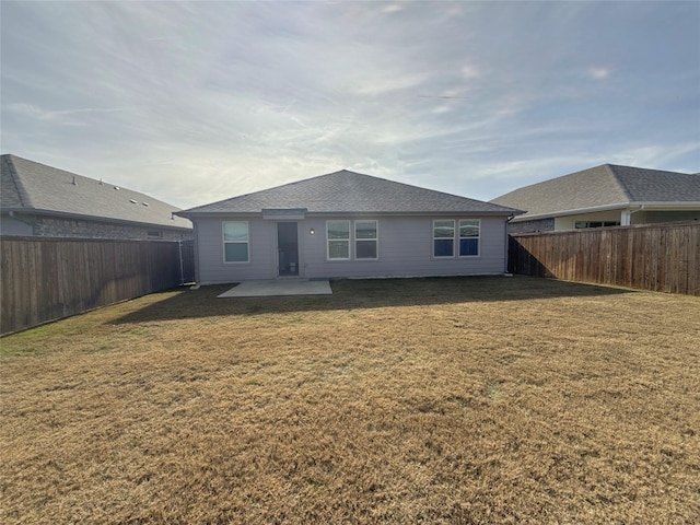 rear view of house featuring a patio and a yard