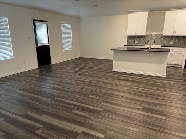 unfurnished living room with dark hardwood / wood-style floors and sink