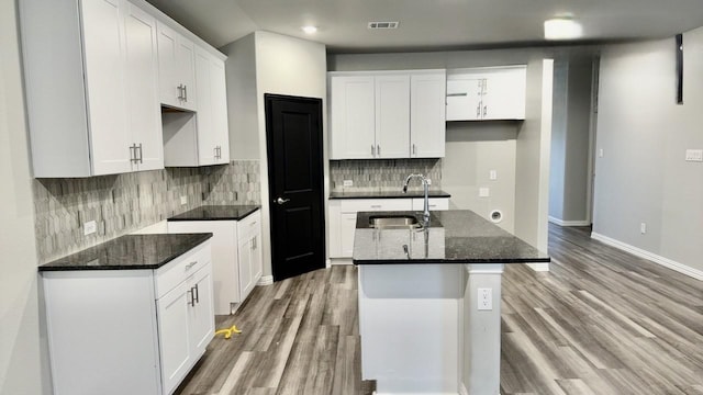 kitchen featuring white cabinetry and sink