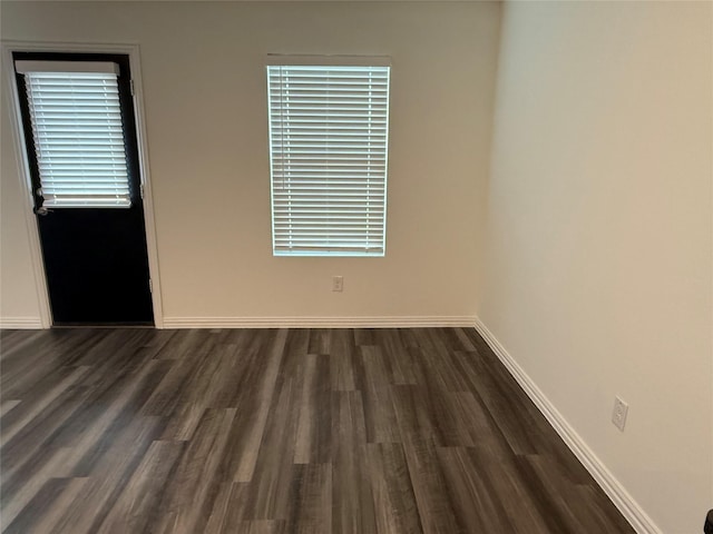 unfurnished room with dark hardwood / wood-style flooring