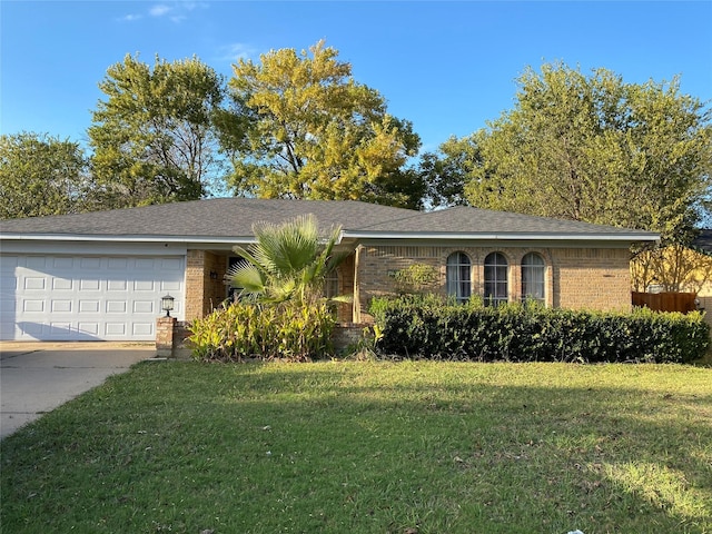 ranch-style home featuring a garage and a front lawn