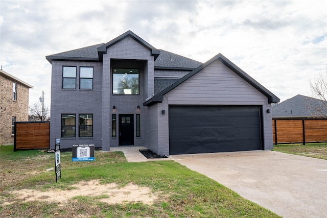 view of front of home featuring a garage and a front yard