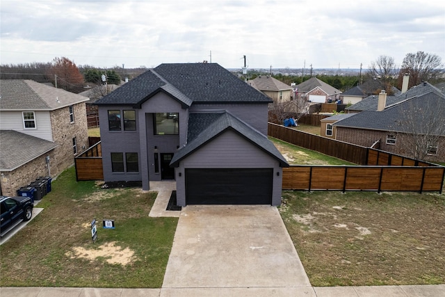 view of front facade with a garage and a front lawn