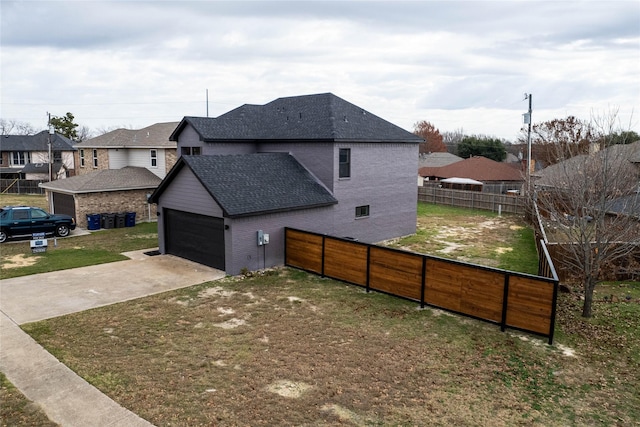 view of home's exterior with a garage and a yard