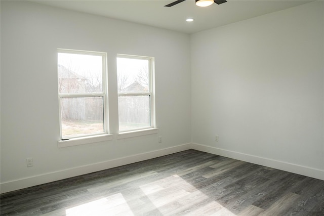 empty room with hardwood / wood-style floors and ceiling fan