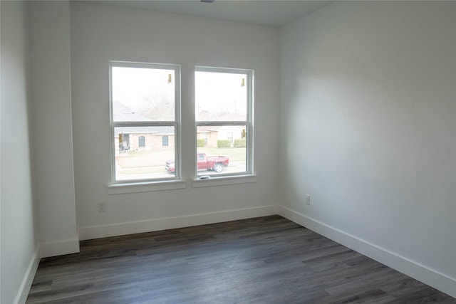 empty room with dark hardwood / wood-style flooring