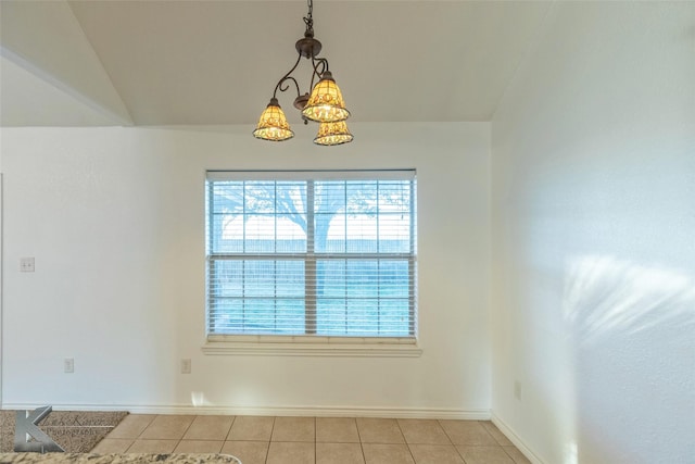 unfurnished dining area with a notable chandelier, lofted ceiling, and light tile patterned floors