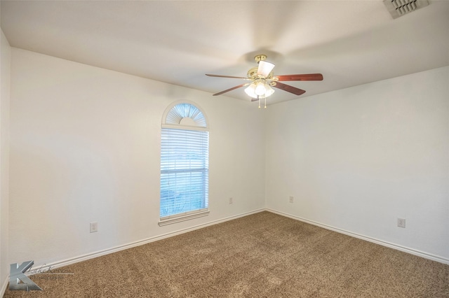 spare room featuring ceiling fan and carpet flooring