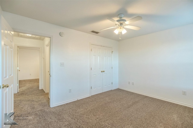 unfurnished bedroom with carpet, ceiling fan, and a closet