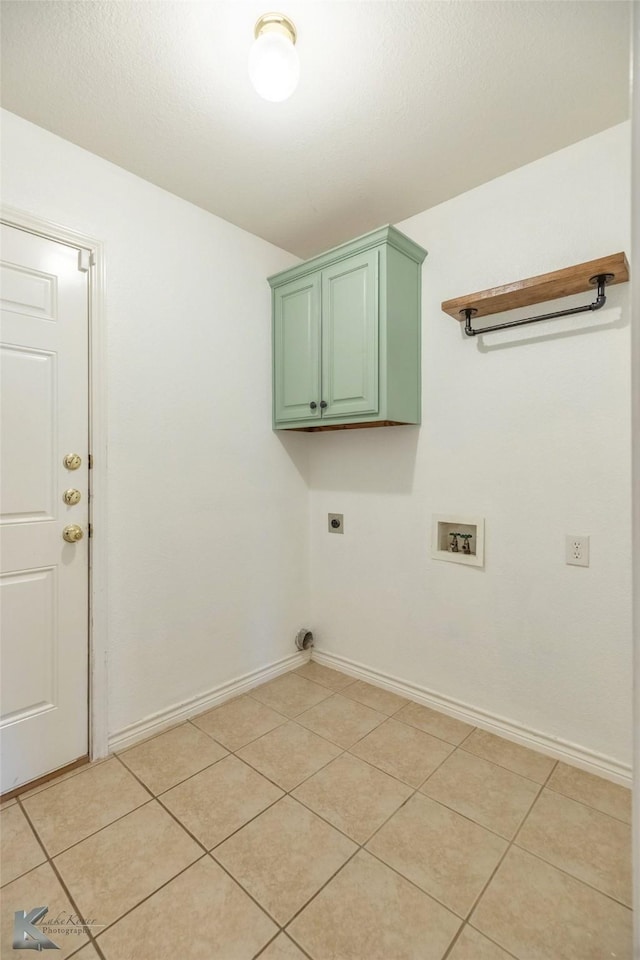 laundry room featuring washer hookup, cabinets, hookup for an electric dryer, and light tile patterned flooring