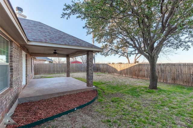 view of yard featuring ceiling fan and a patio