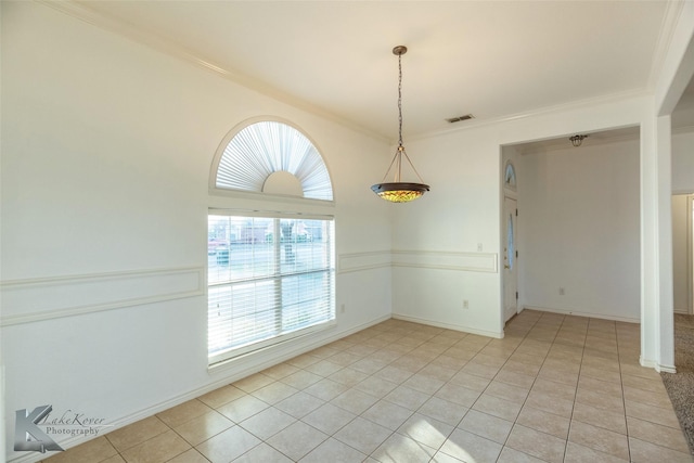 unfurnished room with crown molding and light tile patterned flooring