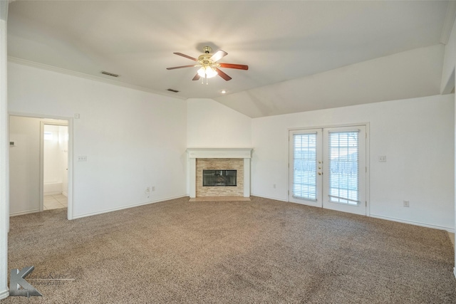 unfurnished living room featuring carpet floors, french doors, ceiling fan, and vaulted ceiling