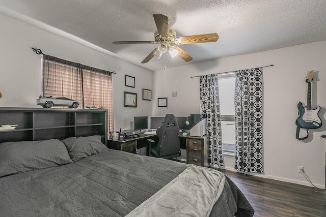 bedroom featuring multiple windows, ceiling fan, dark hardwood / wood-style floors, and a textured ceiling