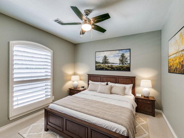 bedroom featuring light carpet and ceiling fan