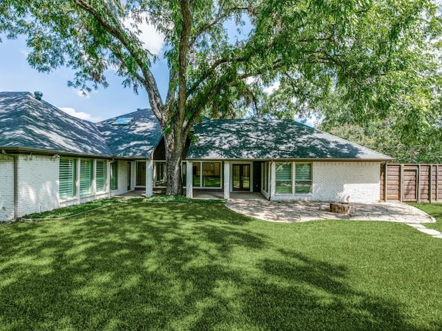 back of property featuring a patio and a lawn