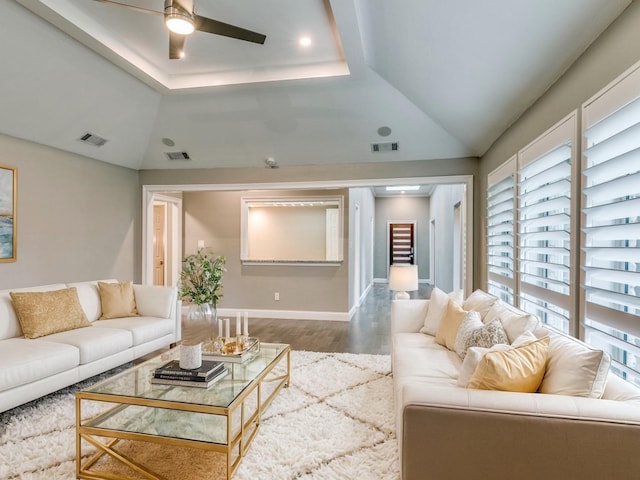 living room featuring lofted ceiling, hardwood / wood-style flooring, and ceiling fan