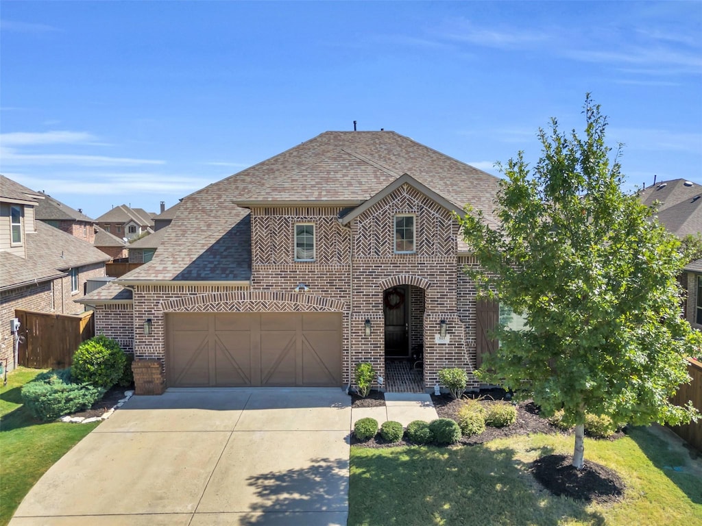 view of front of house featuring a garage and a front yard