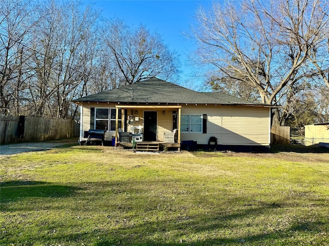 rear view of property with a lawn