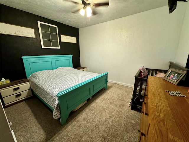 bedroom featuring ceiling fan, light colored carpet, and a textured ceiling