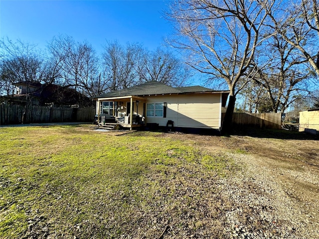 back of property featuring a lawn