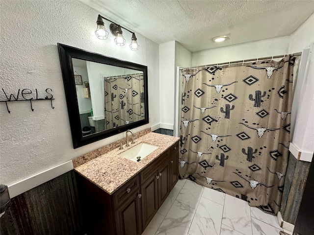 bathroom featuring vanity, curtained shower, and a textured ceiling