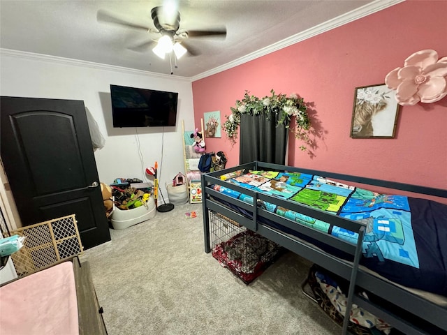 rec room with crown molding, carpet floors, and ceiling fan